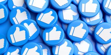 Pile of blue like buttons with thumbs up symbols.