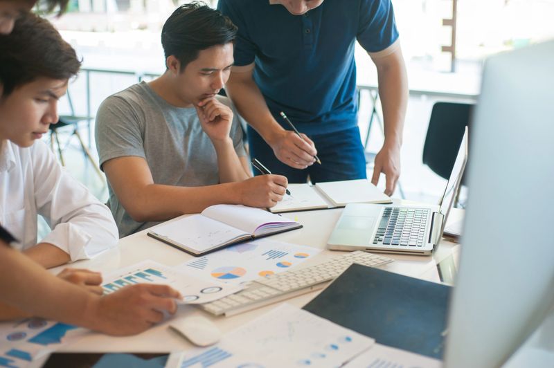 New generation of business people brainstorm ideas to analyze and plan business strategies. Groups of students work together to work on academic research projects.