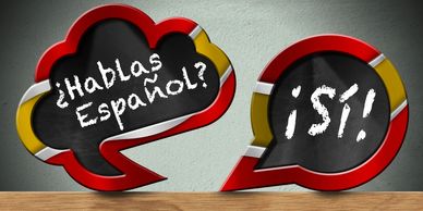Speech bubbles, one saying ¿hablas español? and the other replying ¡sí!