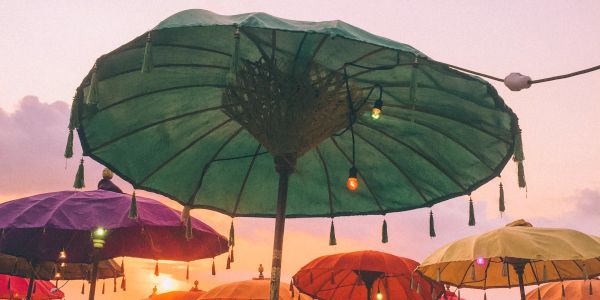 Colorful umbrellas with lights at sunset.