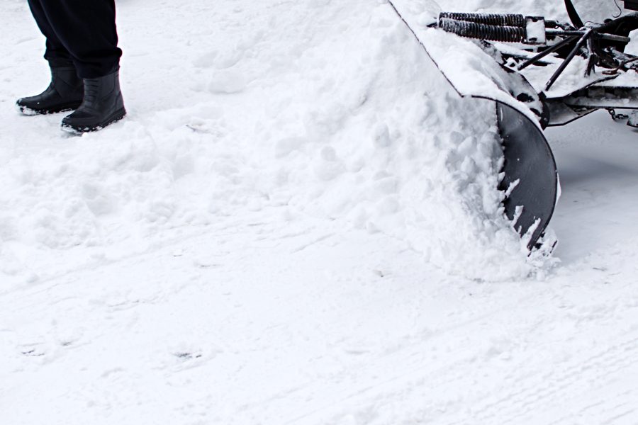 Snow-covered residential driveway plowed clear down to the pavement