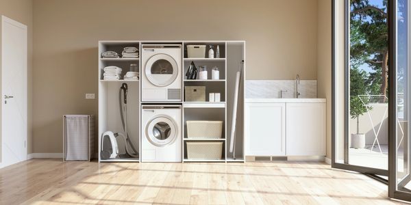 Bright, organized laundry room with washer, dryer, and storage baskets.