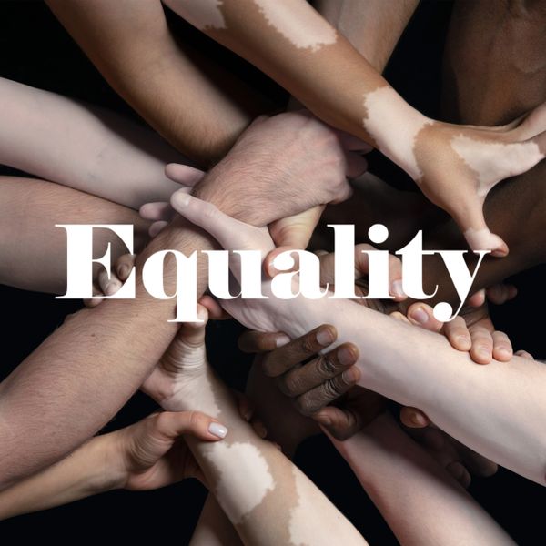 Diverse hands joined together symbolizing equality and unity.