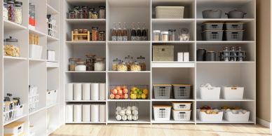 Organized pantry shelves with jars, baskets, and containers.
