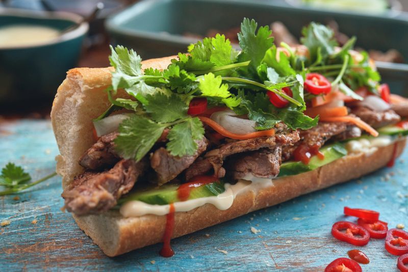 Vietnamese Banh Mi Sandwich with Grilled Pork, Carrots, Cucumber, Radish and Cilantro