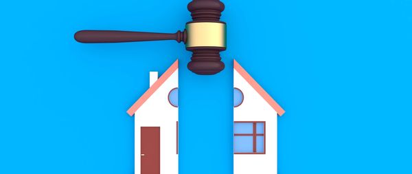 Miniature house models and a succulent plant on a wooden table.