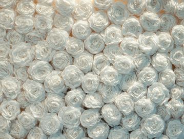 A dense cluster of white roses tightly packed together.