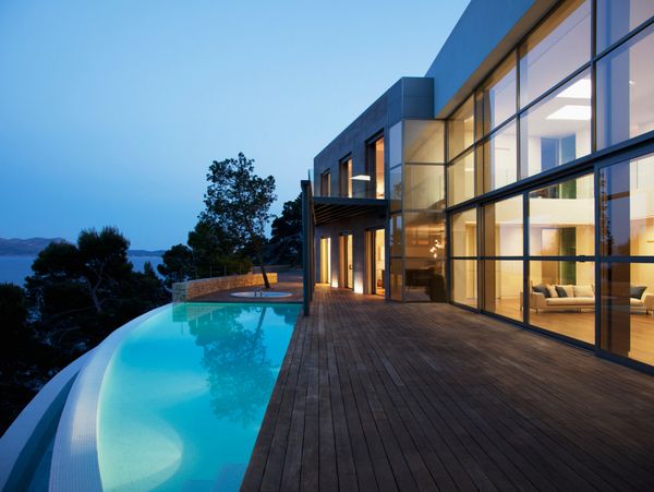 Luxury estate with investment growth symbols.