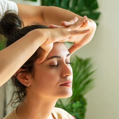 A woman receiving an Ayurvedic Head Massage.