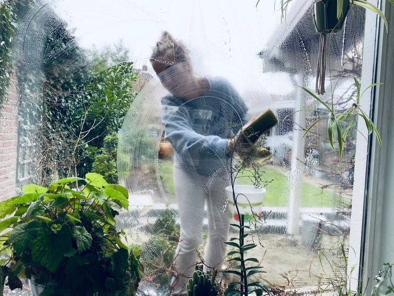 Young Woman cleaning the windows