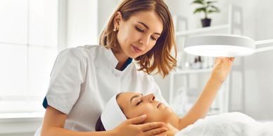 A woman receiving a cosmetic injection in her forehead.