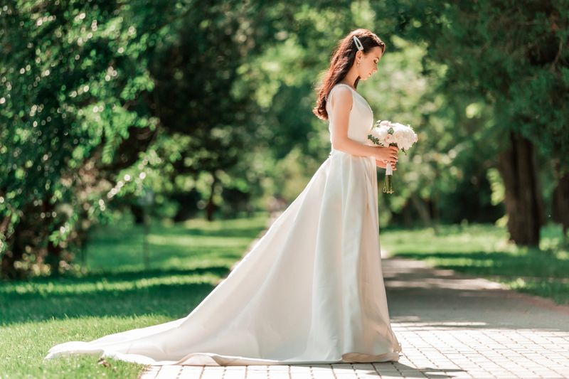 beautiful young woman in wedding dress standing in Park.events and traditions