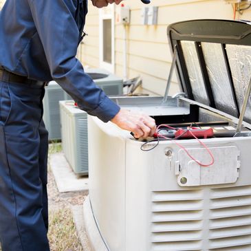 Technician inspecting and testing an outdoor generator with tools.