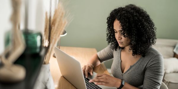Woman working on laptop at home.