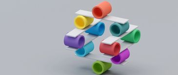 Colorful paper rolls balanced in a 3D geometric arrangement on a gray background.