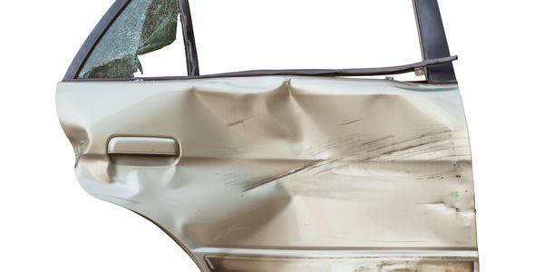 Severely dented and scratched car door with shattered window glass.