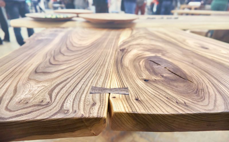 Live edge elm slab table with tree rings inner knot and bow tie joint close view