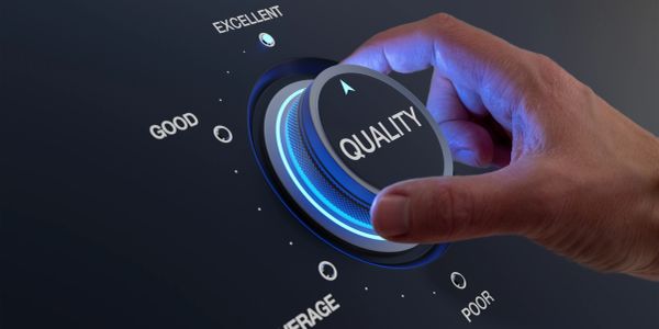 Hand turning a dial labeled 'QUALITY' from good to excellent.