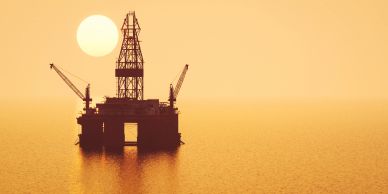 Offshore oil rig at sunset.