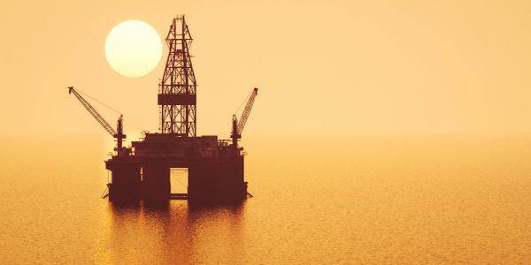 Offshore oil rig at sunset.