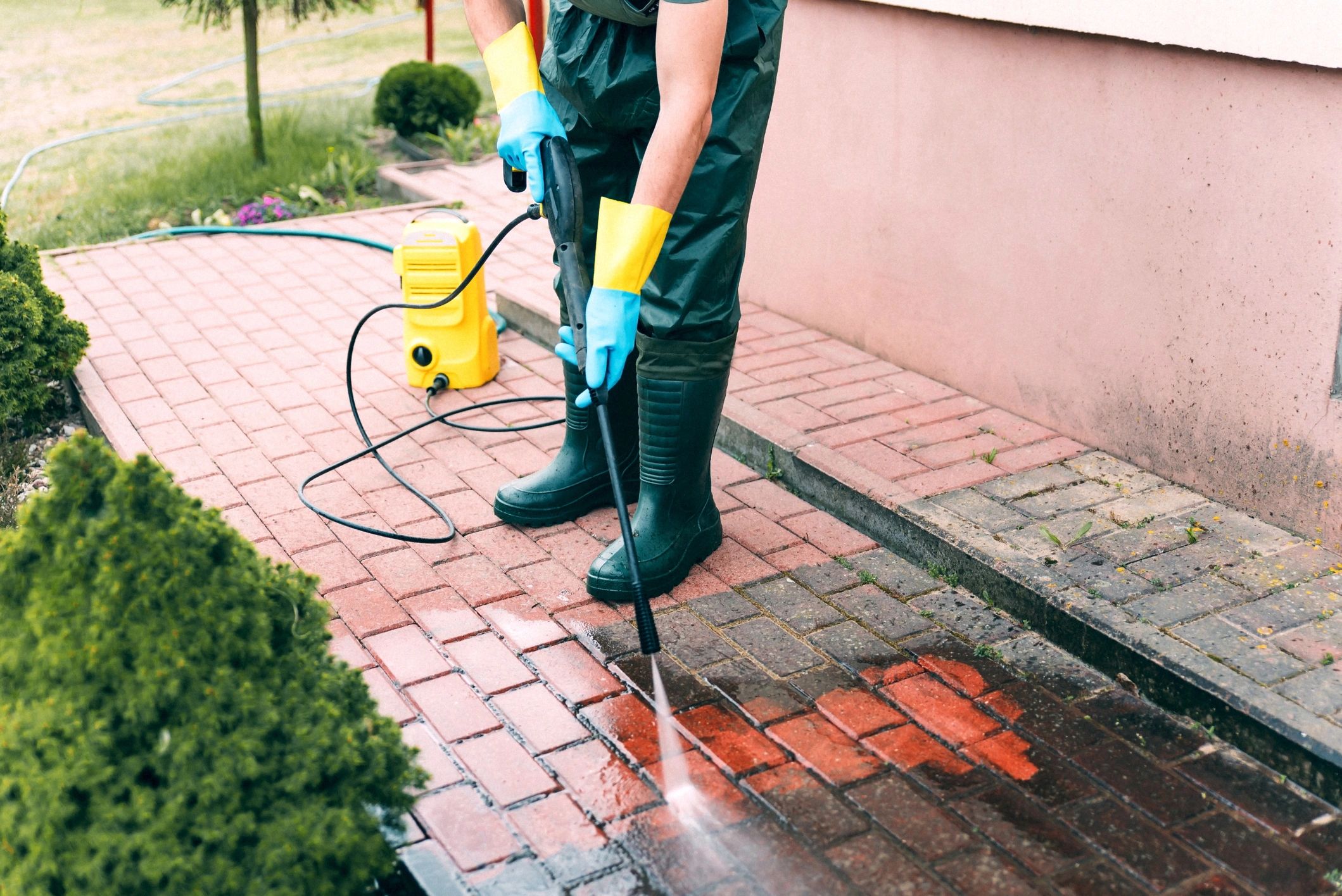 Professional safe pressure cleaning and washing a sidewalk