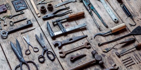 Vintage hand tools arranged on a wooden surface.
