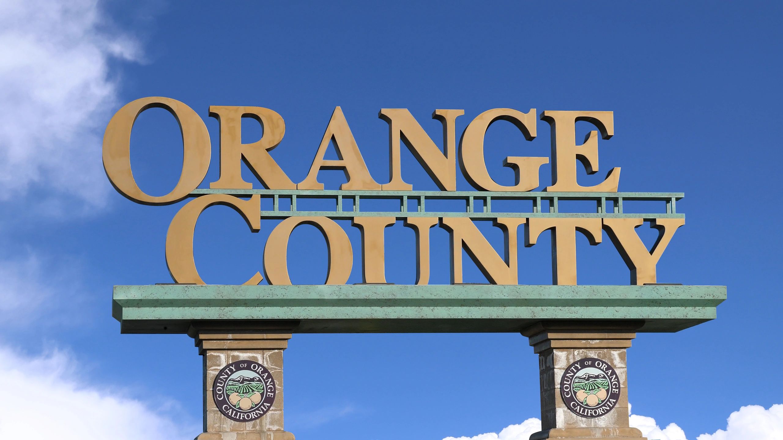 Sign for Orange County, California against blue sky.