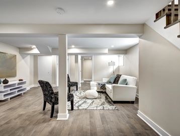 Finished basement featuring a spacious open layout with recessed lighting and vinyl plank flooring