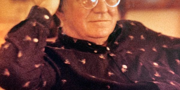 Portrait of an older person with glasses.