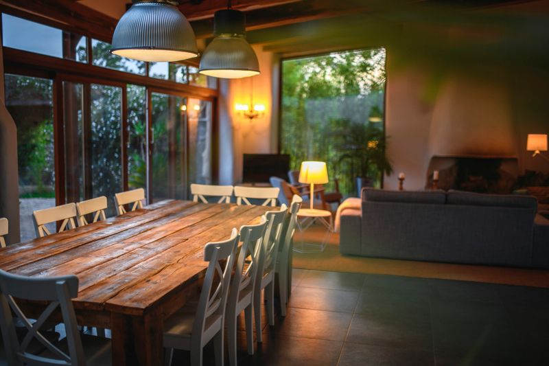 Nice living and dining room in a house in Spain. Green backyard is in the back.