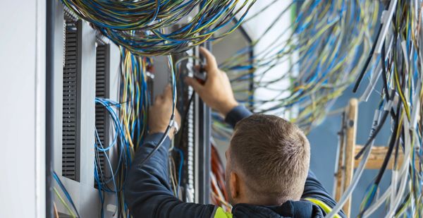 Technician working on server cables.
