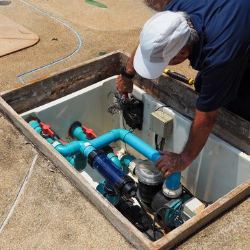 man servicing the pool equipment