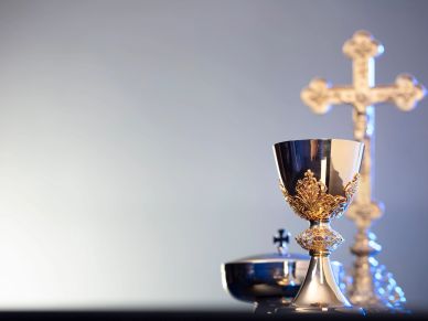 Golden chalice and cross on altar.