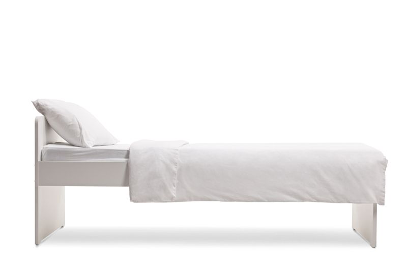 Side shot of a white single bed with a duvet cover isolated on white background