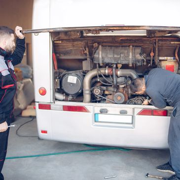 Technician carrying a tool bag into an RV for repair work.