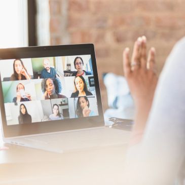 Person participating in a virtual meeting on a laptop.