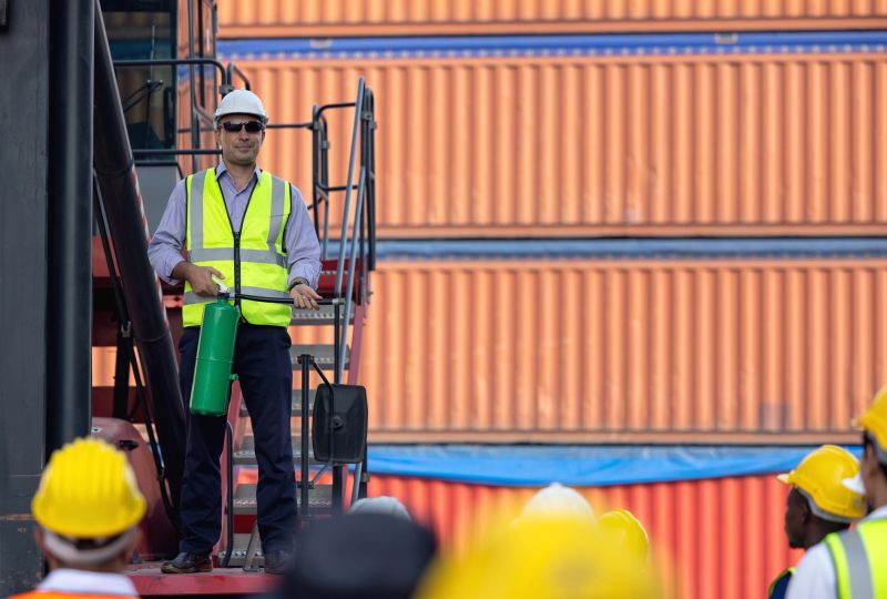 Man with a fire extinguisher training team workers