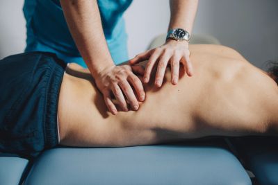 A person receiving a therapeutic back massage.
