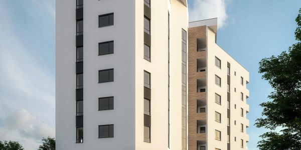 Modern white and wood-paneled apartment building under a blue sky.