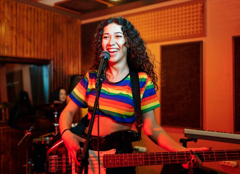 Waist up portrait of contemporary music band rehearsing in studio