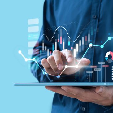 Person interacting with digital financial charts on a tablet.