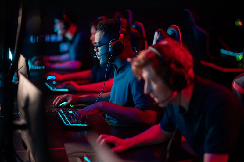 Professional esports players at an online game tournament. The cyber team plays computers and trains.
