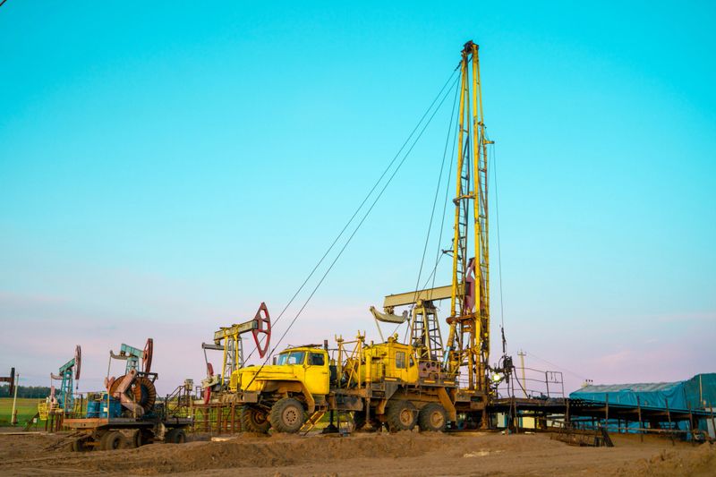 Workover rig working on a previously drilled well trying to restore production through repair. The pumping units and well workover operation