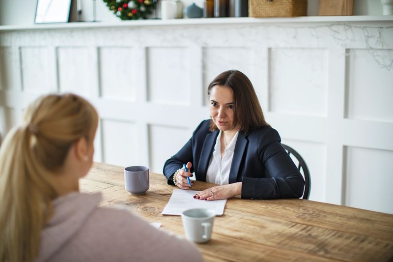 Consultant giving advice to young woman at customer's house