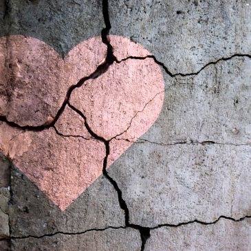Heart painted on cracked wall.
