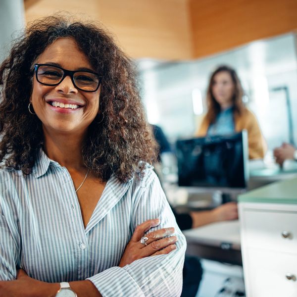 Professional woman smiling confidently in her office.