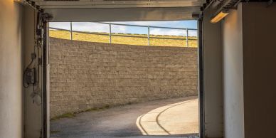 Curved driveway entrance leading to an automated underground parking facility