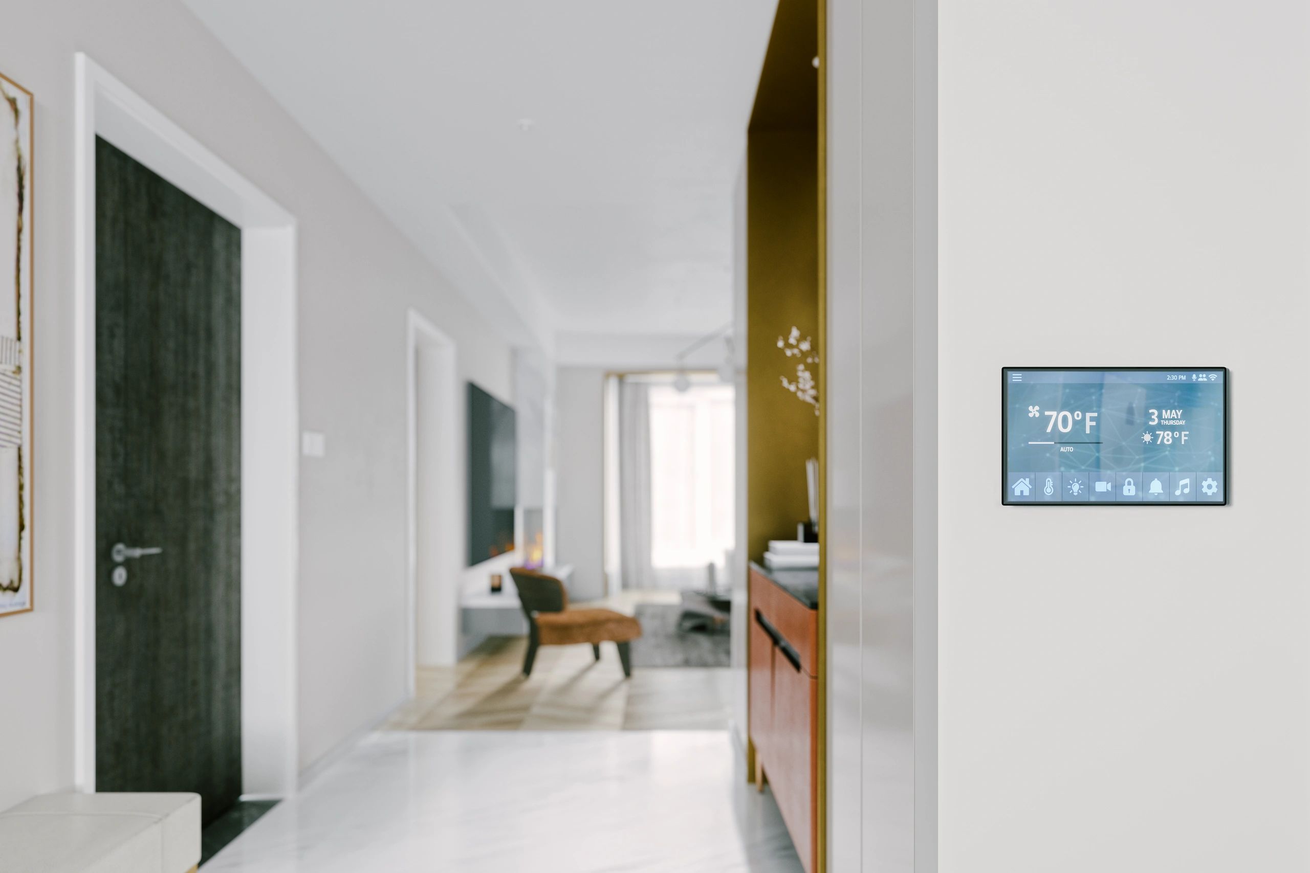 Smart home thermostat on a white wall in a modern living space.