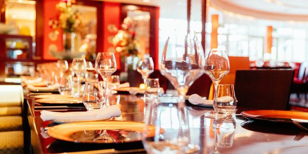 Elegant restaurant table set with glasses and napkins for a formal dining experience.
