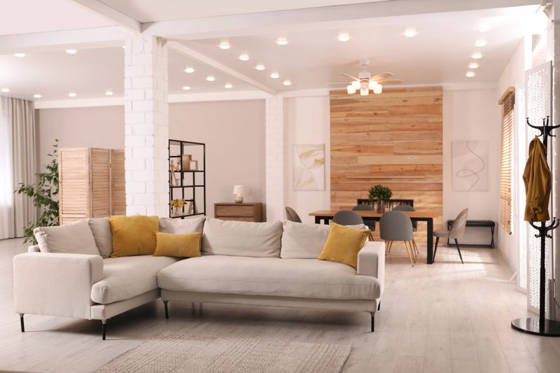 Stylish living room interior with comfortable sofa and wooden table